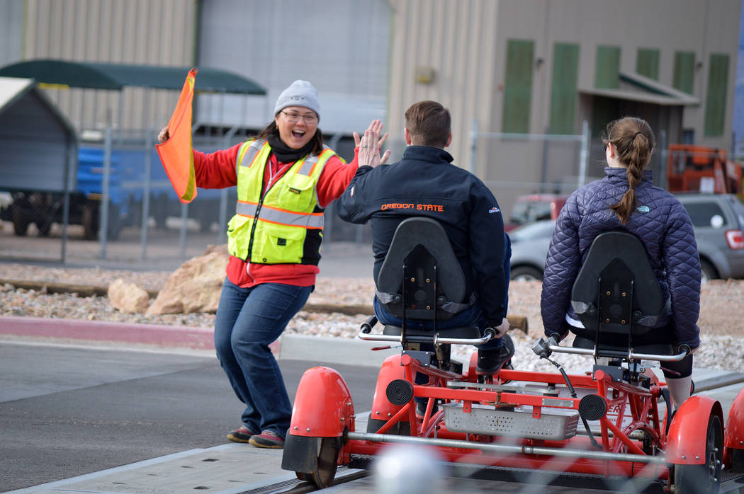Celia Shortt Goodyear/Boulder City Review 
Mary Jo Lu of Rail Explorers high fives a couple on a pedal car Saturday during the company's special day Boulder City residents.