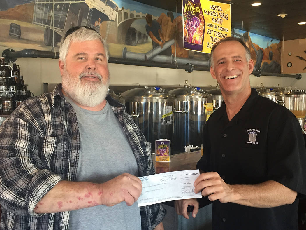 Boulder Dam Brewing Co.
Michael Derby, left, president emeritus of Emergency Aid of Boulder City, accepts a check for $777, proceeds from the Oct. 21 Zombie Walk, from Todd Cook, owner of Boulder  ...