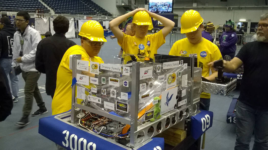 John Richner
High Scalers members, from left, Cooper Cummings, Dustin Landerman and Wyatt Harling prepare the team's robot for another round of competition at a recent event.