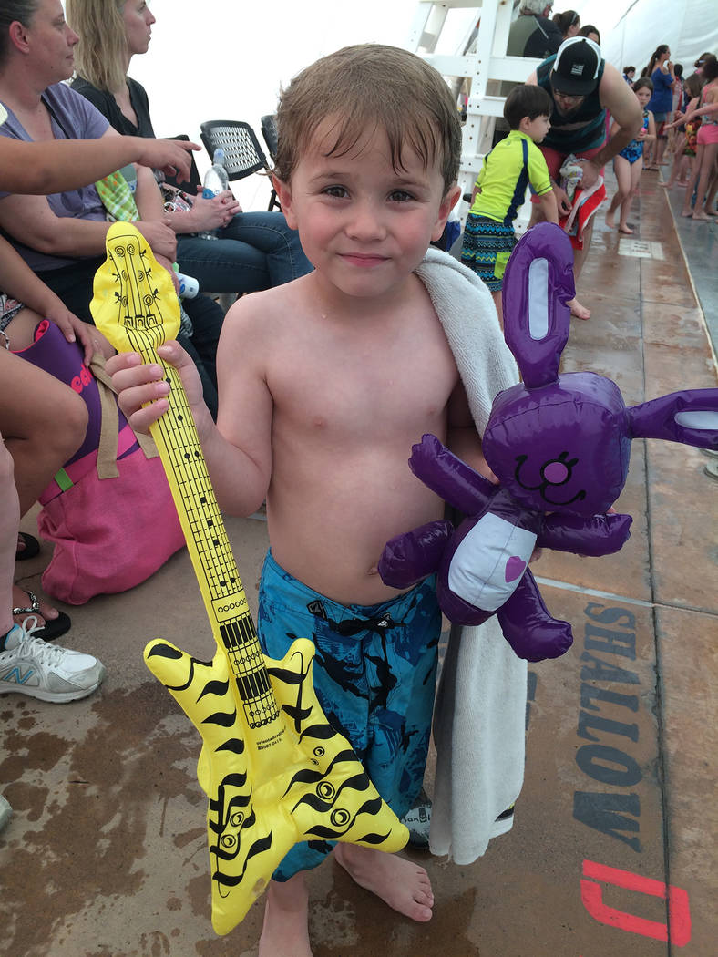 Hali Bernstein Saylor/Boulder City Review
Five-year-old Cole Gansert of Boulder City shows off some of the treasures he found during the Easter pool plunge Saturday at the municipal pool.