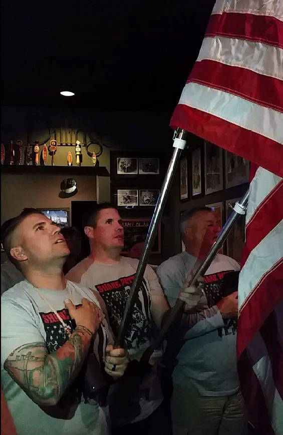 Celia Shortt Goodyear/Boulder City Review
The 2017 Shane Patton Pub Crawl kicks off at The Dillinger with the Pledge of Allegiance led by, from left, Jevan Dixon, Brandon Tretton and John Latham.