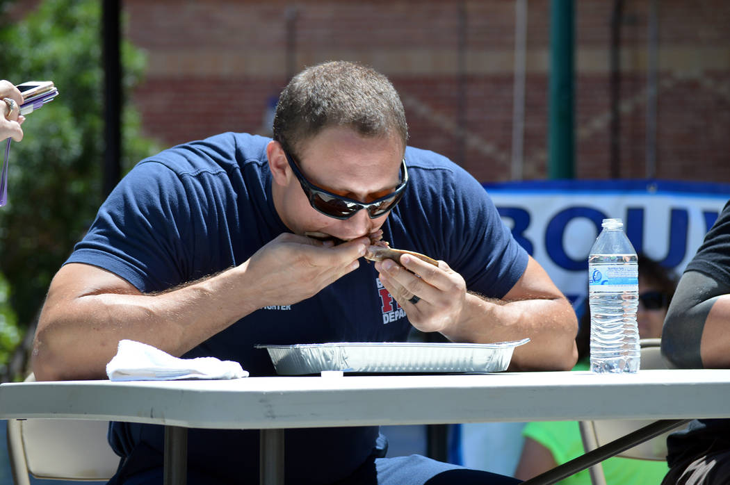 Celia Shortt Goodyear/Boulder City Review
Boulder City firefighter Nigel Walton eats his ribs as fast as he can during the rib-eating contest at the Best Dam Barbecue Challenge on Saturday.