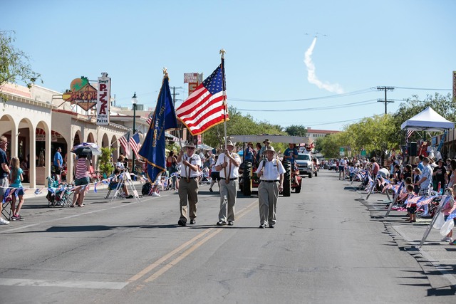 File
Members of the American Legion, Boulder City Post 31, carry the colors at the start of the 68th annual Damboree parade, as the Boulder City Veterans Flying Group makes its way over head in Bo ...