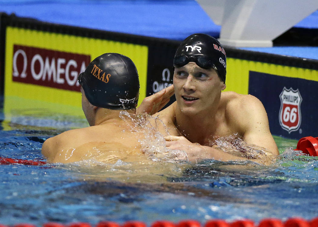 Michael Conroy/The Associated Press
Zane Grothe, right, is congratulated by second-place finisher Clark Smith after winning men's 400-meter freestyle at the U.S. swimming national championships in ...