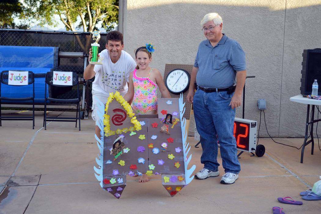 Celia Shortt Goodyear/Boulder City Review
Boulder City Mayor Rod Woodbury, left, and City Councilman Kiernan McManus, right, award 8-year-old Kallie Irwin with first prize in the &quot;Most Or ...