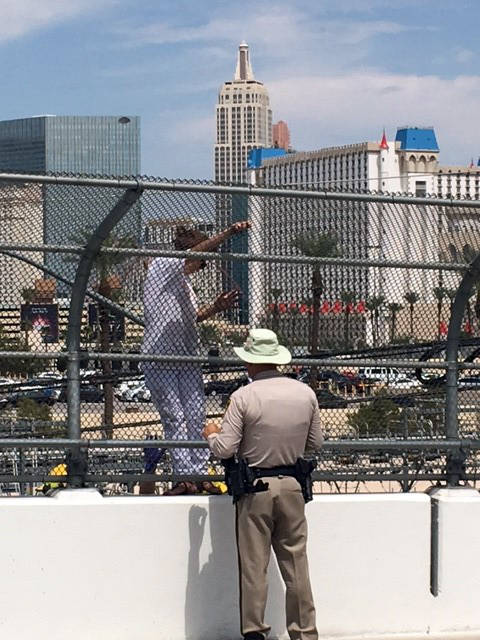 Valarie Vanario-Mullins
Officer Timothy Mullins helps a woman who was threatening to jump from an overpass above Interstate 15 in Las Vegas.