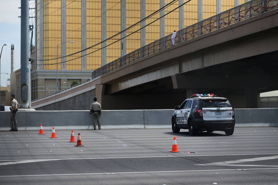 Erik Verduzco/Las Vegas Review-Journal
A woman hangs off the Mandalay Bay overpass and above Interstate 15 in Las Vegas, on Monday, Sept. 4. After Metropolitan Police Department officer Timothy Mu ...