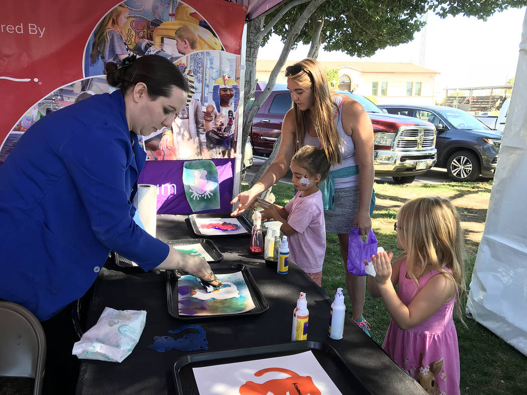 Hali Bernstein Saylor/Boulder City Review
Angela Burnett, left, of Children's Discovery Museum in Las Vegas, helps Teagan Holmes, 6, of Las Vegas, far right, create a painting of her own as Sophia ...