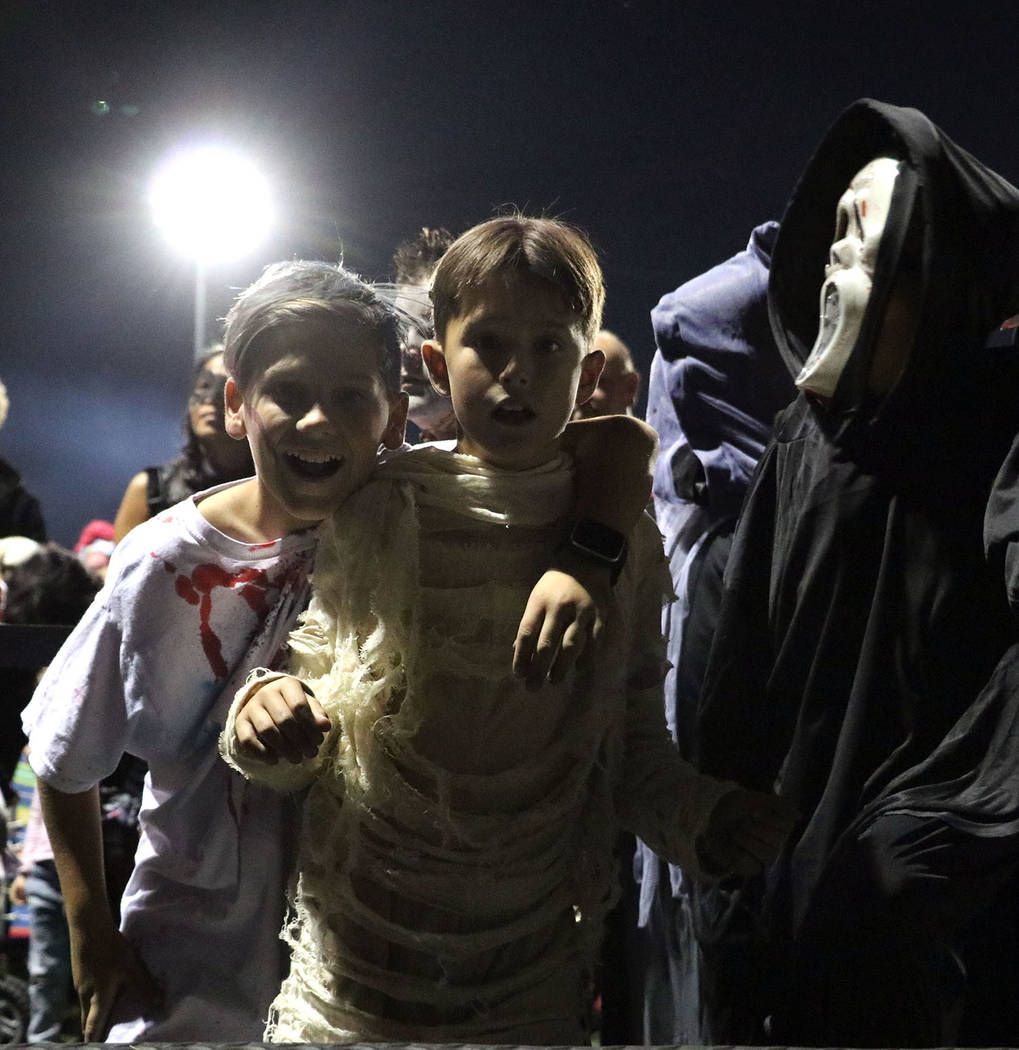 Tristin Phelps/Boulder City Review
Two boys eagerly wait to show off their scary costumes in the scariest costume competition during the Trunk or Treat festitivies at Veterans' Memorial Park on Sa ...