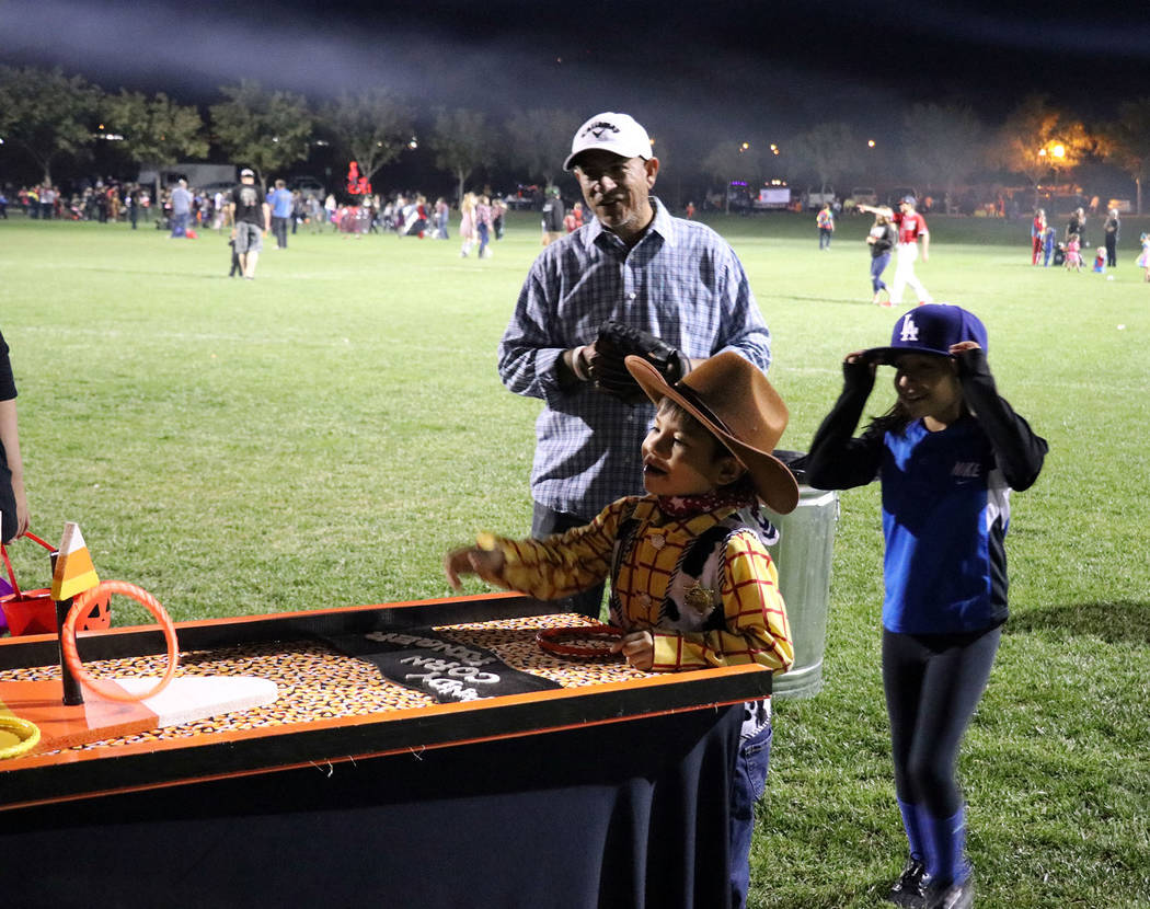 Tristin Phelps/Boulder City Review
A young boy, dressed as Woody from "Toy Story," tosses rings around the candy corn loops to win a prize during the annual Trunk or Treat celebration Saturday at  ...