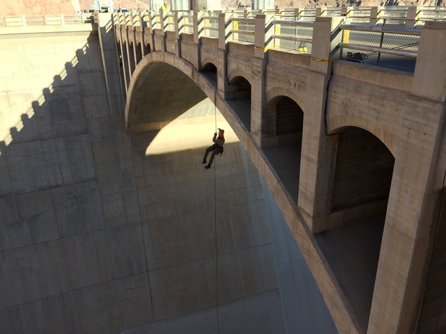 Photo courtesy Bureau of Reclamation
Nathaniel Gee hangs from a rope while inspecting the bridge over the Arizona spillway at Hoover Dam on Oct. 19, 2016.