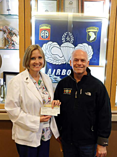 Courtesy photo
Poppy Helgren, director of nursing at the Nevada State Veterans Home, accepts a $861 donation from Todd Ferguson of the Southern Nevada 7-Eleven Community Involvement group on Dec. 23.