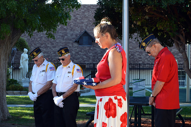 Max Lancaster/Boulder City Review
Grace Christian Academy Principal Devon Tilman, center, bows her head in prayer, retired flag in hand, as members of American Legion, Post 31, and students and fa ...