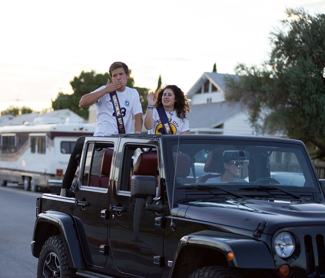Noel Kanaley/Boulder City Review
Members of Boulder City High School's senior Homecoming Court Ben Missel and Skylor McKay make their way slowly on Fifth Street toward California Avenue as family, ...