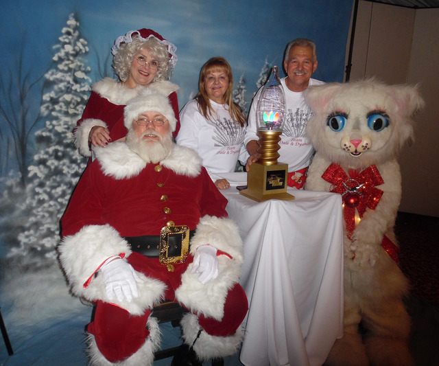 Hali Bernstein Saylor/Boulder City Review
Dyanah Musgrave and Dale Ryan join Santa and Mrs. Claus and Jingle Cat to show off the trophy they won competing in ABC's "The Great Christmas Light Fight ...