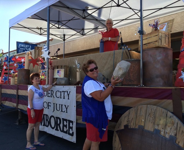 In preparation for the 68th annual Damboree celebration and parade, Pam Walters, from left, Sandra Fraser and Ziggy Pawlowski decorate one of the announcers' stands on Nevada Way early Monday, Jul ...