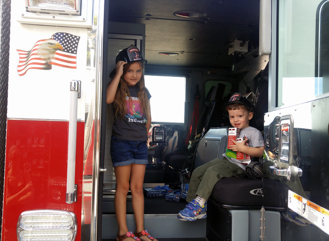 Hunter Terry/Boulder City Review
Alex Radan, left, and Riley O'Connor explored the fire engines after enjoying syrup-soaked pancakes at the annual firefighters pancake breakfast Saturday at the Bo ...
