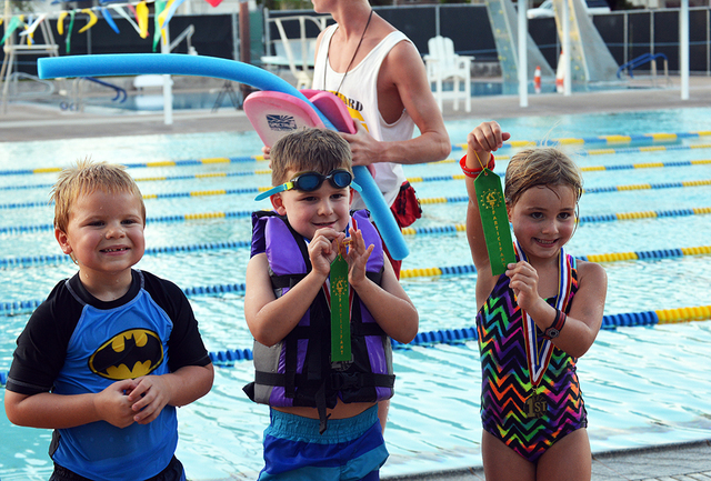 Five-year-olds, from left, Lee Sheldon, Drew Huysentruyt and Taylor Reeves show off their medals after racing their boats during the Boulder City Parks and Recreation Departments 16th annual Cardb ...