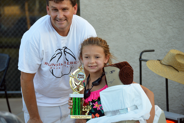 Mekenzie Martorano, 7, is presented the third-place trophy for best Rebel boat by Mayor Rod Woodbury during the parks and recreation department's 16th annual Cardboard Boat Race on July 20. Mekenz ...