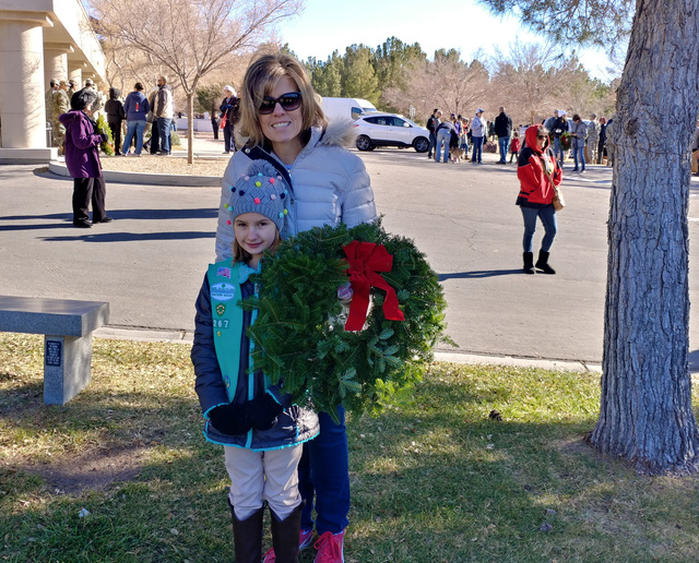 Hunter Terry/Boulder City Review
Shannon and Grace Dickenson, in front, of Las Vegas, attended the Wreaths Across America ceremony Saturday at Southern Nevada Veterans Memorial Cemetery to pay the ...