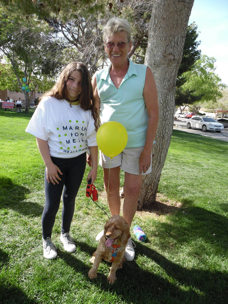File
Airyanna Chavez, left, visits with Mona Goddard and her foster dog, Tweekers, during last year's Rock, Roll & Stroll fundraiser for the Senior Center of Boulder City. This year's event is sch ...