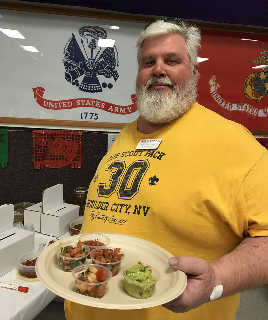 Hali Bernstein Saylor/Boulder City Review
Mike Derby, past president of Emergency Aid of Boulder City, gathers a plate full of salsa and other dips to try during Boulder City Elks Lodge's Mexican  ...