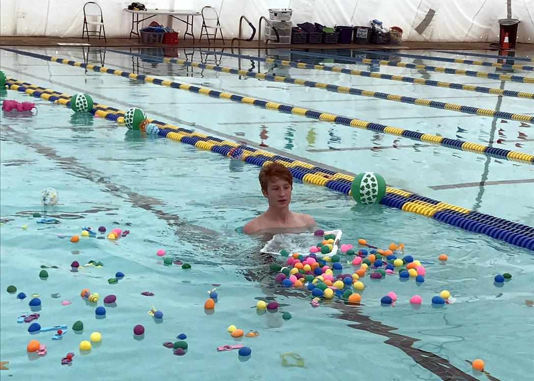 Hali Bernstein Saylor/Boulder City Review
Lifeguard Tyson Morris helps spread plastic eggs in the municipal pool before the start of one of three egg hunts during the third annual Easter Pool Plun ...