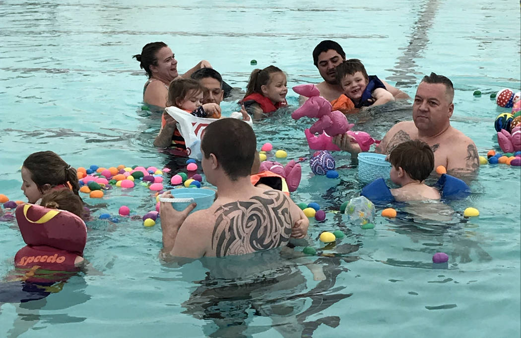 Hali Bernstein Saylor/Boulder City Review
Children in the 0-5 age division, assisted by parents, gather plastic eggs and floating toys during the third annual Easter Pool Plunge on Saturday, March ...