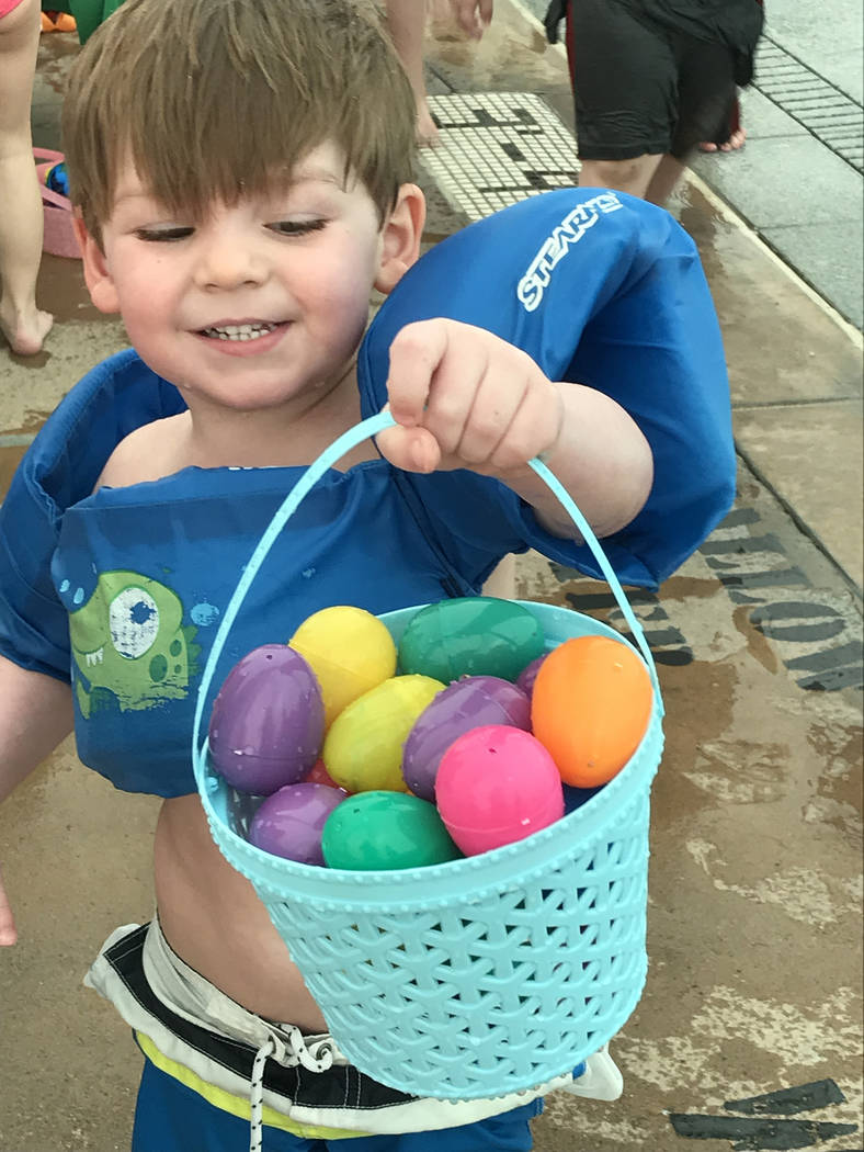Hali Bernstein Saylor/Boulder City Review
Braxden Cristo, 3, shows off the bucket of eggs he collected during the third annual Easter Pool Plunge on Saturday, March 17, 2018, at the municipal pool.