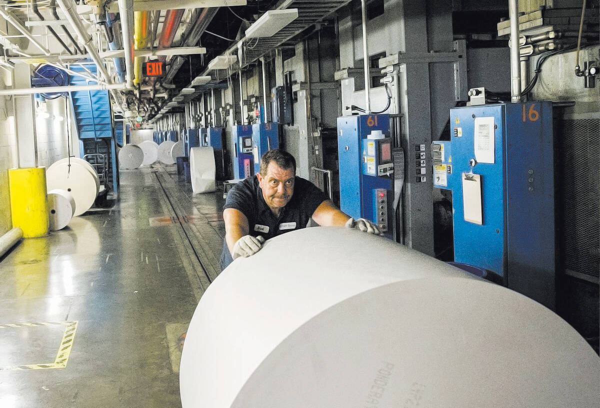 Newsprint Coordinator Brad Nielson conducts a change over in the press room of the Las Vegas Re ...
