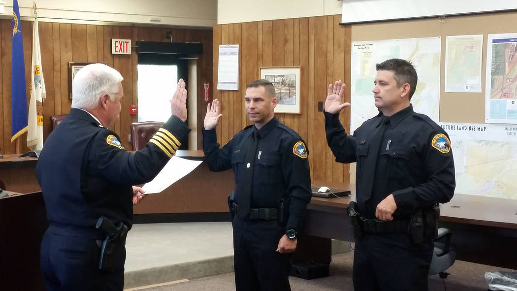 Celia Shortt Goodyear/Boulder City Review
Boulder City Police Chief Tim Shea, left, swears in Boulder City's two newest police officers, Mike Petty, center, and Bret Hood, on Monday during a cerem ...