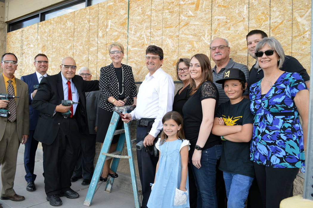 Celia Shortt Goodyear/Boulder City Review
City officials and the Medo family get ready to say goodbye to the plywood on the windows of the old Vons/Haggen store on Boulder City Parkway, from left, ...