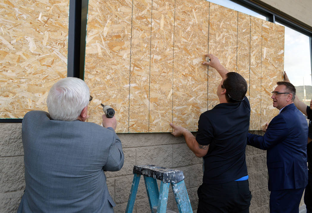 Celia Shortt Goodyear/Boulder City Review
Councilman Kiernan McManus, left, helps Aaron Medo, center, and City Manager Al Noyola remove plywood from the old Vons/Haggen store on Boulder City Parkway.