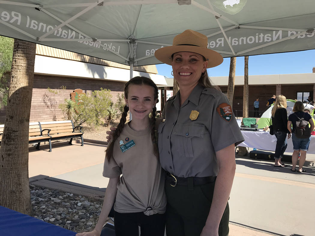 Hali Bernstein Saylor/Boulder City Review Stephanie McMartin, left, junior ranger ambassador for Lake Mead, helped her mother Sylvia McMartin check in prospective junior rangers during Saturday's ...