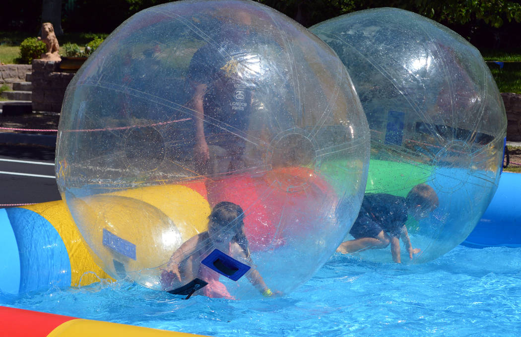 Allie Gates, left, and Porter Burr enjoy the Bubble Fun water ride during the Spring Jamboree last year. This year's family-fun event will be held Saturday and Sunday, May 5 and 6.