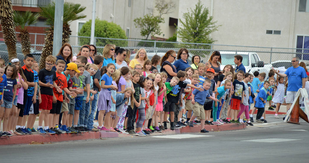 Celia Shortt Goodyear/Boulder City Review Elementary school students wait for their turn to high-five members of Boulder City High School's class of 2018 during the Grad Walk on Monday, May 21. Th ...