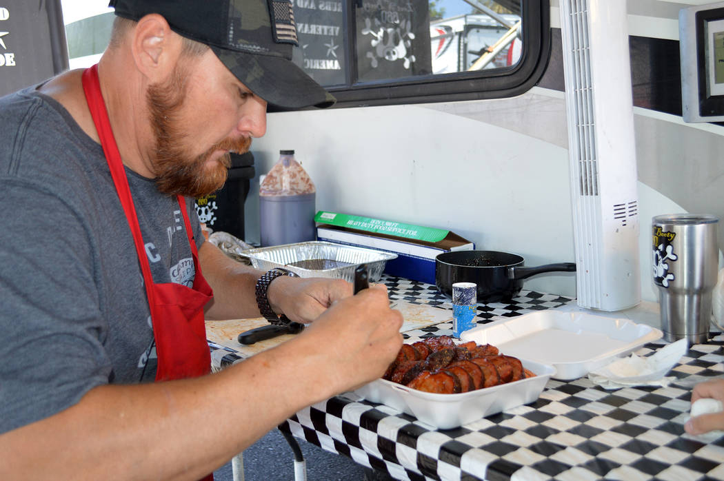 File Sterling Smith, pitmaster of Loot N' Booty BBQ, prepares his pork shoulder for the judges at the 2017 Best Dam Barbecue Challenge. This year's event will be held Friday and Saturday in Bicent ...