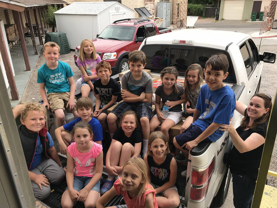 Hali Bernstein Saylor/Boulder City Review Second-graders in Azure Quinlan's class at Mitchell Elementary School collected food to donate to Emergency Aid of Boulder City. On Monday, Quinlan, far r ...