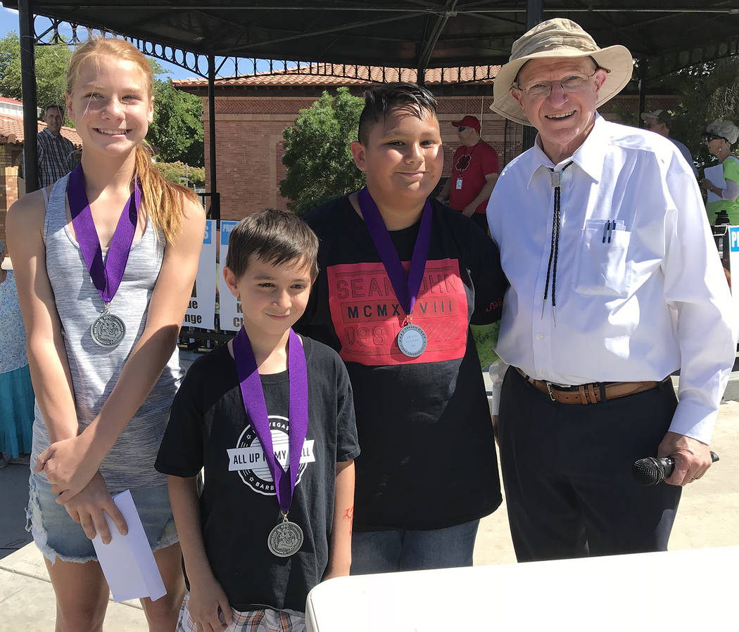 Hali Bernstein Saylor/Boulder City Review Addison Doane, from left, Dean Barr and Sebastian Herandez, winners of the youth division of the KidsQue contest for children 6-12, are congratulated by S ...
