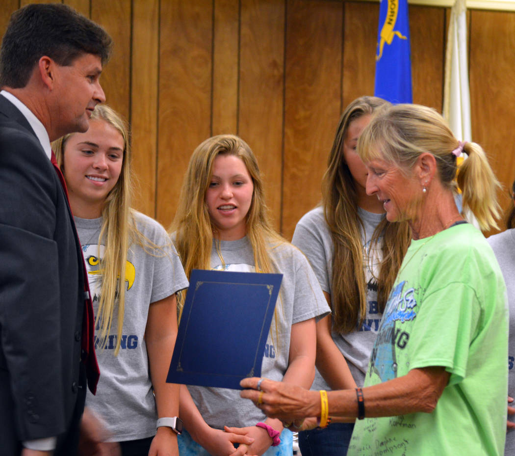 Celia Shortt Goodyear/Boulder City Review Mayor Rod Woodbury presents Boulder City High School Swim Coach Sara Carroll with a certificate of achievement at the City Council meeting Tuesday for the ...