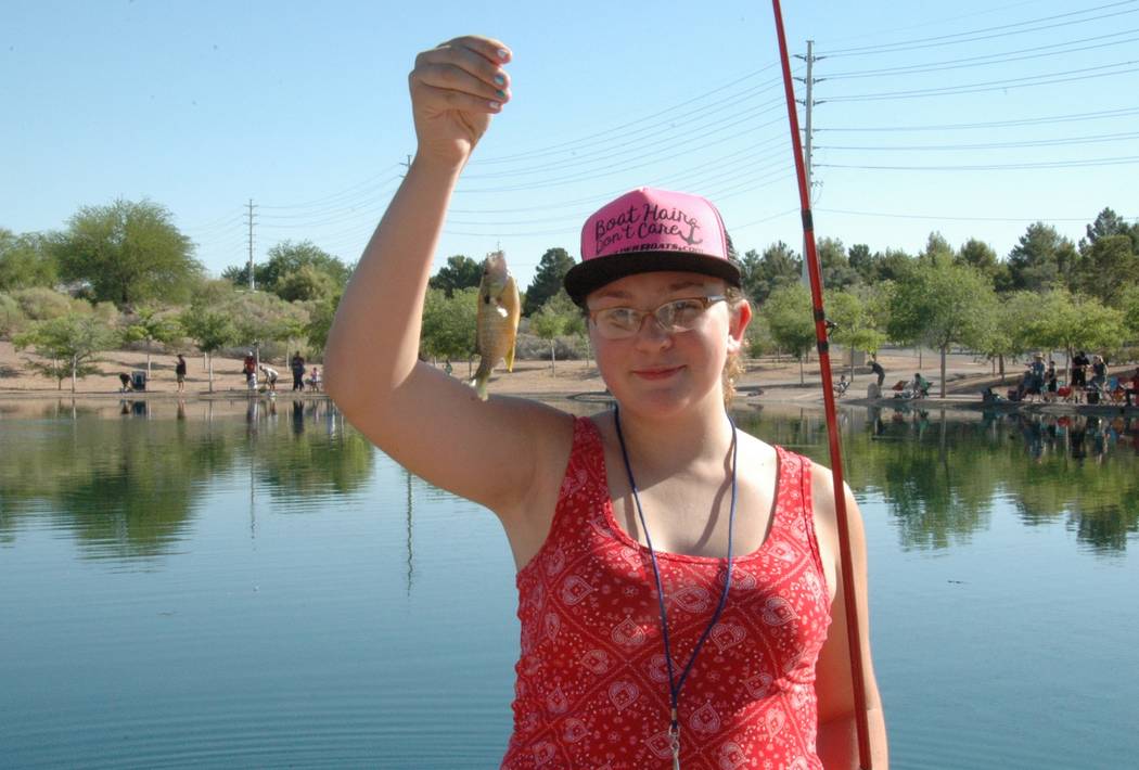 Jayme Sileo/Boulder City Review Lucy Finkel and her second fish of the day, a sunfish. She was among the dozens of families that came to Veterans' Memorial Park on Saturday for Free Fishing Day.
