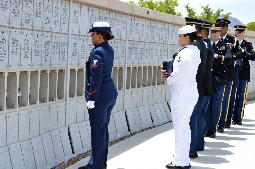 Celia Shortt Goodyear/Boulder City Review Members of the United States military carry the remains of 35 unclaimed veterans to their final resting places Friday at the Southern Nevada Veterans Ceme ...