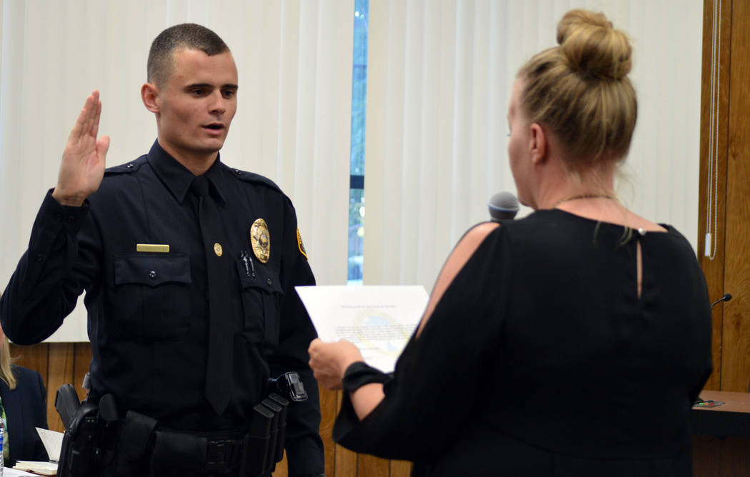 Celia Shortt Goodyear/Boulder City Review Giovanni Torcaso is sworn in to the Boulder City Police Department by City Clerk Lorene Krumm at the City Council meeting Tuesday. Torcaso is a former Bou ...