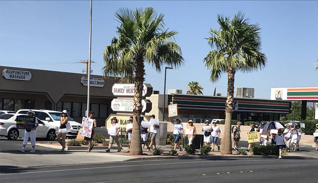 Hali Bernstein Saylor/Boulder City Review Boulder City residents marched single file along Nevada Way on Saturday to protest separating children from their parents as part of President Donald Trum ...