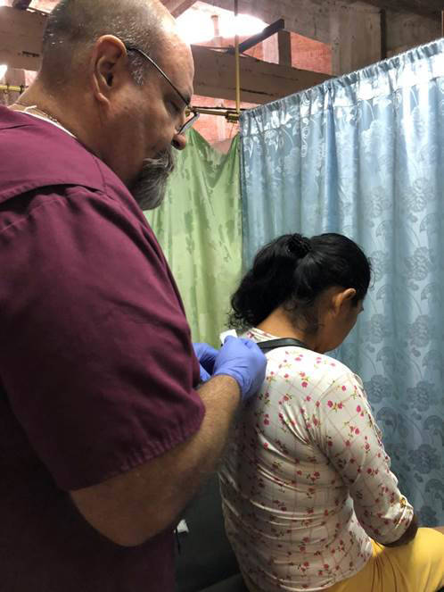 Larry Smith Dr. Larry Smith of Boulder City prepares to give a woman an injection that will help relieve her pain during a recent trip to Ecuador as part of Healing Hands Abroad.