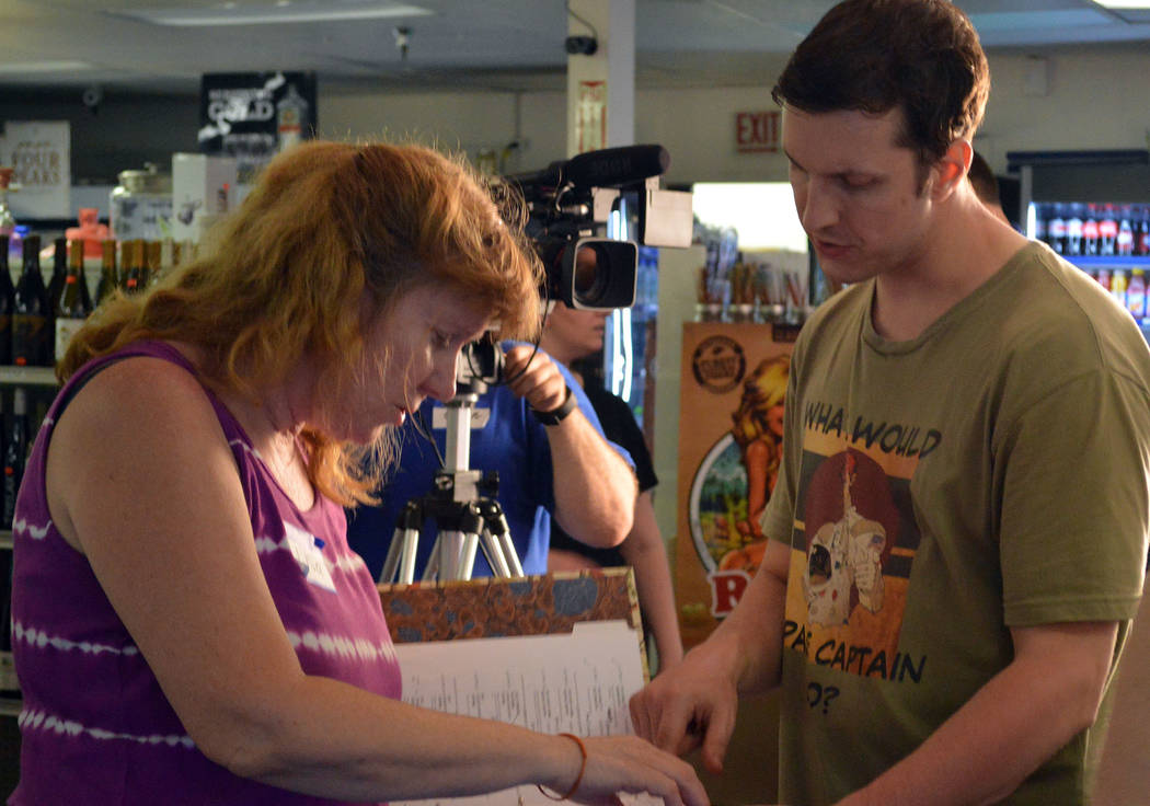 Celia Shortt Goodyear/Boulder City Review Local writer and producer Lisa Savy goes over the script for her movie "Space Captain and Callista" at BC Liquor, 806 Buchanan Blvd., with Las Vegas actor ...