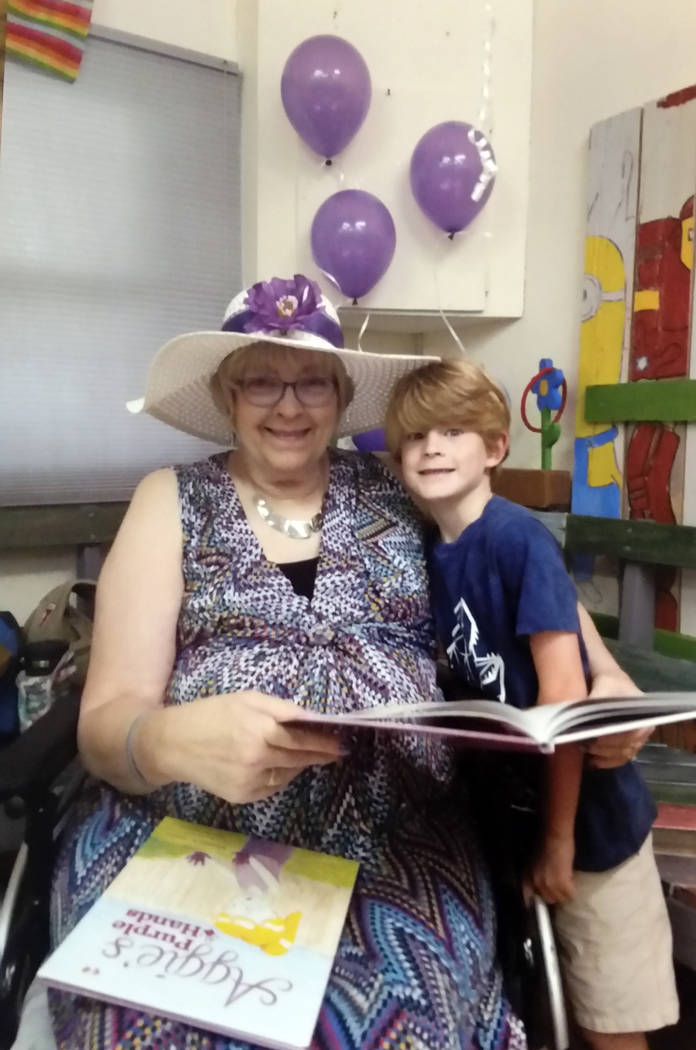 Rhonda Gatlin Author Rhonda Gatlin reads her new book, "Aggie's Purple Hands," with her grandson, Oliver Osbourn, at at a book signing Aug. 2 at Ruben's Wood Craft and Toys in Boulder City.