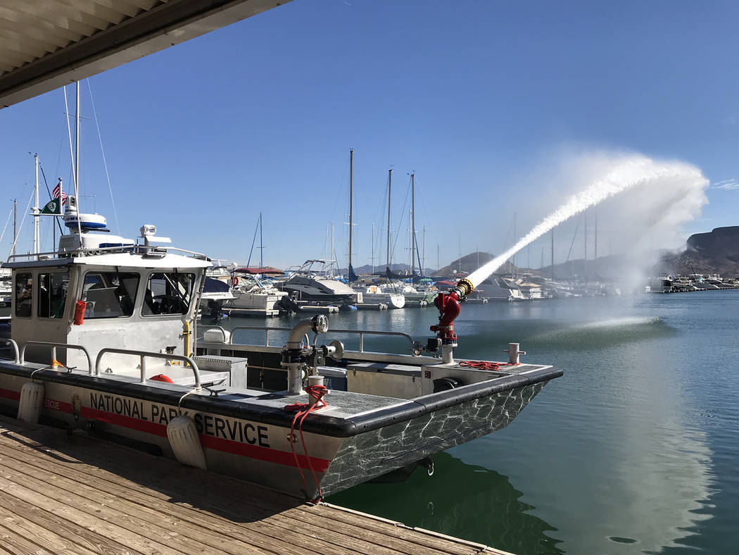 Hali Bernstein Saylor/Boulder City Review Rangers at Lake Mead National Recreation Area demonstrate how water can be pumped from its new fireboat during a dedication ceremony Friday.