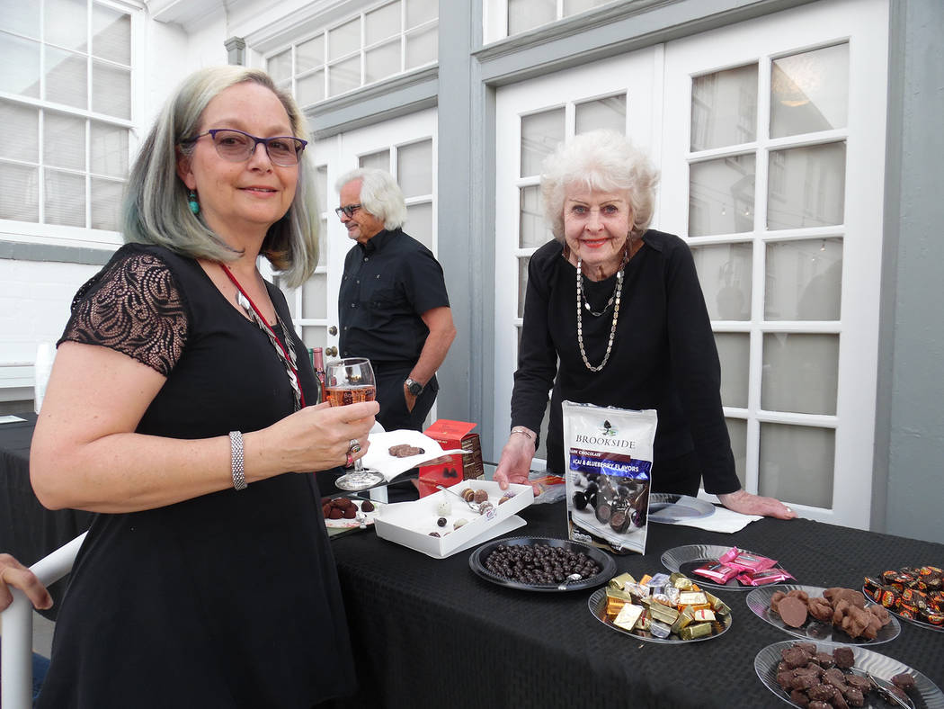 File Donna Hieleman, left, looks over the selection of chocolates available as Barb Morris makes recommendations during last year's chocolate and wine tasting event presented by the Boulder City b ...