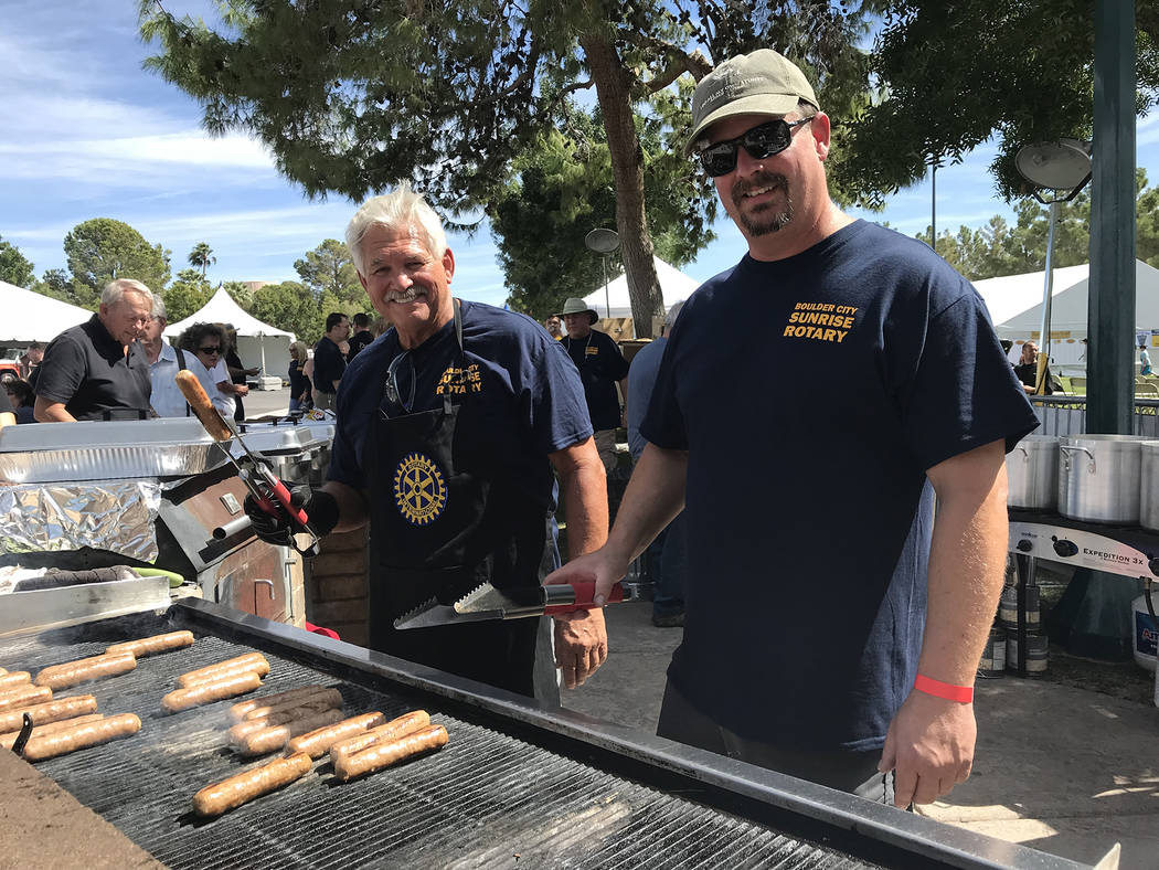 Hali Bernstein Saylor/Boulder City Review Dale Ryan, left, and Jim Parsons man the grill at Saturday's Wurst Festival presented by the Boulder City Sunrise Rotary club in Bicentennial Park.